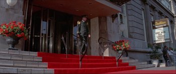 Movie still from “Prime Cut” (1972), directed by Michael Ritchie – A man in uniform walking down a set of stairs; Wide shot, Low angle
