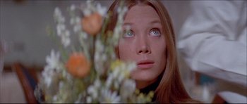 Movie still from “Prime Cut” (1972), directed by Michael Ritchie – A beautiful young woman looking at the camera; Close Up shot, Low angle