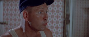 Movie still from “Prime Cut” (1972), directed by Michael Ritchie – A person wearing a hat; Close Up shot, Low angle