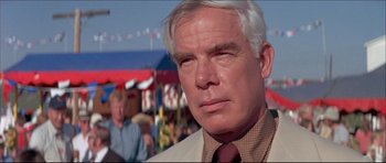 Movie still from “Prime Cut” (1972), directed by Michael Ritchie – An older man wearing a suit and a tie; Close Up shot, Over the shoulder angle