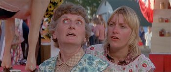 Movie still from “Prime Cut” (1972), directed by Michael Ritchie – Two women looking up at something in the distance; Close Up shot, Low angle