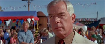 Movie still from “Prime Cut” (1972), directed by Michael Ritchie – An older man in a white suit and red neck tie; Close Up shot, Low angle