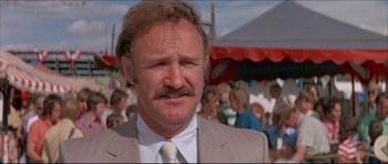 Movie still from “Prime Cut” (1972), directed by Michael Ritchie – A person wearing a suit and a tie; Close Up shot, Low angle