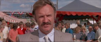 Movie still from “Prime Cut” (1972), directed by Michael Ritchie – A person wearing a suit and tie; Close Up shot, Low angle