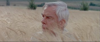 Movie still from “Prime Cut” (1972), directed by Michael Ritchie – An older man with white hair in a wheat field; Close Up shot, Low angle