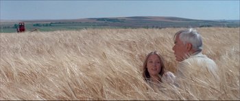 Movie still from “Prime Cut” (1972), directed by Michael Ritchie – A woman is in a field of wheat looking at the camera; Wide shot, High angle