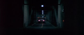 Movie still from “Prime Cut” (1972), directed by Michael Ritchie – A car driving down a dark street at night; Extreme Wide shot, Low angle