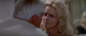 Movie still from “Prime Cut” (1972), directed by Michael Ritchie – An older man and a beautiful woman looking at one another; Close Up shot, Over the shoulder angle