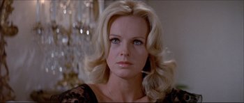 Movie still from “Prime Cut” (1972), directed by Michael Ritchie – A person with long hair and blue eyes; Close Up shot, Low angle