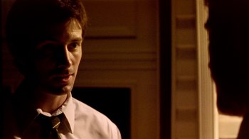 Movie still from “Primer” (2004), directed by Shane Carruth – A man wearing a white dress shirt and a tie; Close Up shot, Over the shoulder angle