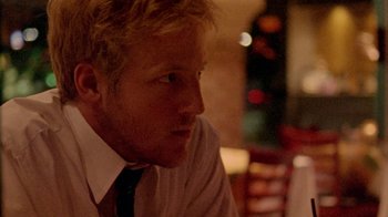 Movie still from “Primer” (2004), directed by Shane Carruth – A person sitting at a table; Close Up shot, Over the shoulder angle