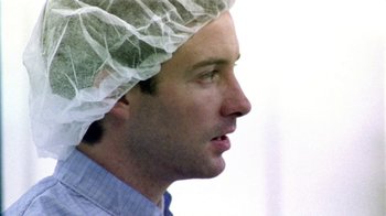 Movie still from “Primer” (2004), directed by Shane Carruth – A person wearing a head covering; Close Up shot, Low angle