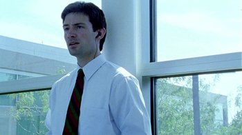 Movie still from “Primer” (2004), directed by Shane Carruth – A man in a white shirt and a red and green striped tie; Close Up shot, Low angle