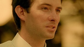 Movie still from “Primer” (2004), directed by Shane Carruth – A man's face in a white shirt; Extreme Close Up shot, Low angle