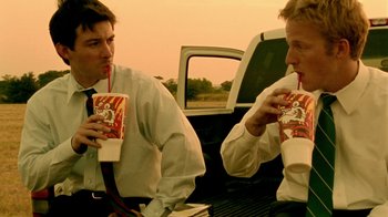 Movie still from “Primer” (2004), directed by Shane Carruth – A couple of men sitting next to each other; Medium shot, Low angle