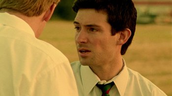 Movie still from “Primer” (2004), directed by Shane Carruth – A man wearing a white dress shirt and a green neck tie talking to another man wearing a white dress shirt and a green neck tie; Close Up shot, Over the shoulder angle