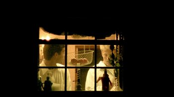 Movie still from “Primer” (2004), directed by Shane Carruth – Two men are looking out of a window at pizza; Medium shot, Low angle