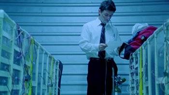 Movie still from “Primer” (2004), directed by Shane Carruth – A man in a white dress shirt and a black tie; Medium shot, Low angle