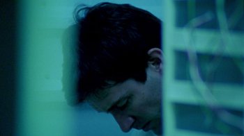 Movie still from “Primer” (2004), directed by Shane Carruth – A man with his head in his hands; Close Up shot, Low angle