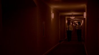 Movie still from “Primer” (2004), directed by Shane Carruth – A man walking down a hallway in a hotel room; Extreme Wide shot, High angle