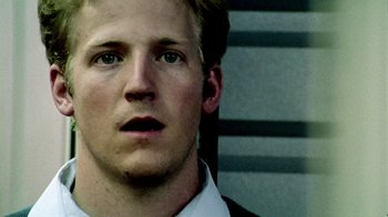 Movie still from “Primer” (2004), directed by Shane Carruth – A person wearing a white shirt; Close Up shot, Low angle