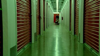 Movie still from “Primer” (2004), directed by Shane Carruth – A long hallway with many storage units in it; Extreme Wide shot, Low angle
