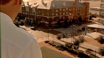 Movie still from “Primer” (2004), directed by Shane Carruth – An aerial view of an urban area with buildings and trees; Extreme Close Up shot, High angle