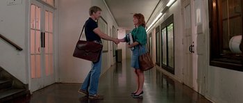 Movie still from “Prince of Darkness” (1987), directed by John Carpenter – A man and a woman shaking hands in a hallway; Wide shot, Low angle