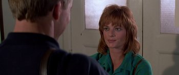 Movie still from “Prince of Darkness” (1987), directed by John Carpenter – A man and a woman talking in front of a mirror; Close Up shot, Over the shoulder angle