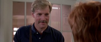 Movie still from “Prince of Darkness” (1987), directed by John Carpenter – A man with a mustache standing next to a woman; Close Up shot, Low angle