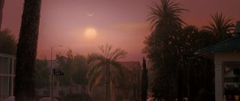 Movie still from “Prince of Darkness” (1987), directed by John Carpenter – The sun is setting over a residential neighborhood; Extreme Wide shot, High angle