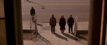 Movie still from “Prince of Darkness” (1987), directed by John Carpenter – A group of people standing on a sidewalk; Wide shot, High angle