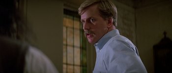 Movie still from “Prince of Darkness” (1987), directed by John Carpenter – A person with a mustache; Close Up shot, Low angle