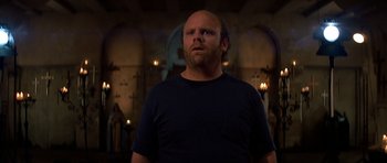 Movie still from “Prince of Darkness” (1987), directed by John Carpenter – A man with a bald head is standing in a room; Close Up shot, Low angle