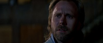 Movie still from “Prince of Darkness” (1987), directed by John Carpenter – A person with long hair and a beard; Close Up shot, Low angle