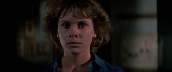 Movie still from “Prince of Darkness” (1987), directed by John Carpenter – A person wearing a blue shirt; Close Up shot, Low angle