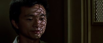 Movie still from “Prince of Darkness” (1987), directed by John Carpenter – A person's face with shadows on it; Close Up shot, Low angle