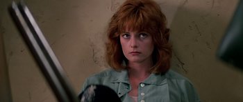 Movie still from “Prince of Darkness” (1987), directed by John Carpenter – A person holding a mirror; Close Up shot, Low angle