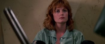 Movie still from “Prince of Darkness” (1987), directed by John Carpenter – A person with long red hair; Close Up shot, Low angle