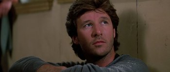 Movie still from “Prince of Darkness” (1987), directed by John Carpenter – A person wearing a shirt; Close Up shot, Low angle