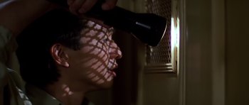 Movie still from “Prince of Darkness” (1987), directed by John Carpenter – A woman blow drying her hair with a blow dryer; Close Up shot, Low angle