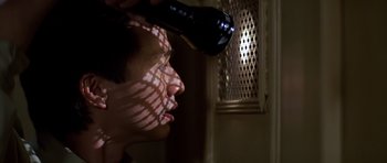 Movie still from “Prince of Darkness” (1987), directed by John Carpenter – A person blow drying another person's hair with a blow dryer; Close Up shot, Low angle