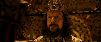 Movie still from “Prince of Persia: The Sands of Time” (2010), directed by Mike Newell – A man with a beard wearing a gold crown; Close Up shot, High angle