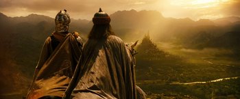 Movie still from “Prince of Persia: The Sands of Time” (2010), directed by Mike Newell – A man riding on the back of a white horse; Wide shot, Low angle