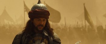 Movie still from “Prince of Persia: The Sands of Time” (2010), directed by Mike Newell – A man with long brown hair wearing a helmet; Close Up shot, Low angle