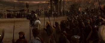Movie still from “Prince of Persia: The Sands of Time” (2010), directed by Mike Newell – A group of people on horses in a desert; Wide shot, High angle