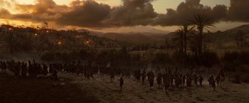 Movie still from “Prince of Persia: The Sands of Time” (2010), directed by Mike Newell – A group of people are gathered in a field; Extreme Wide shot, High angle