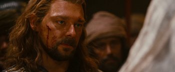 Movie still from “Prince of Persia: The Sands of Time” (2010), directed by Mike Newell – A person with a beard; Close Up shot, Over the shoulder angle