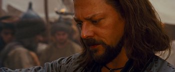 Movie still from “Prince of Persia: The Sands of Time” (2010), directed by Mike Newell – A person with long hair and a beard; Close Up shot, Over the shoulder angle
