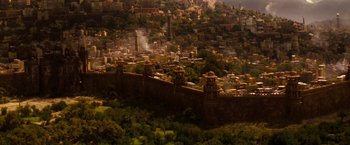 Movie still from “Prince of Persia: The Sands of Time” (2010), directed by Mike Newell – An aerial view of a city with buildings and trees in the background; Extreme Wide shot, High angle